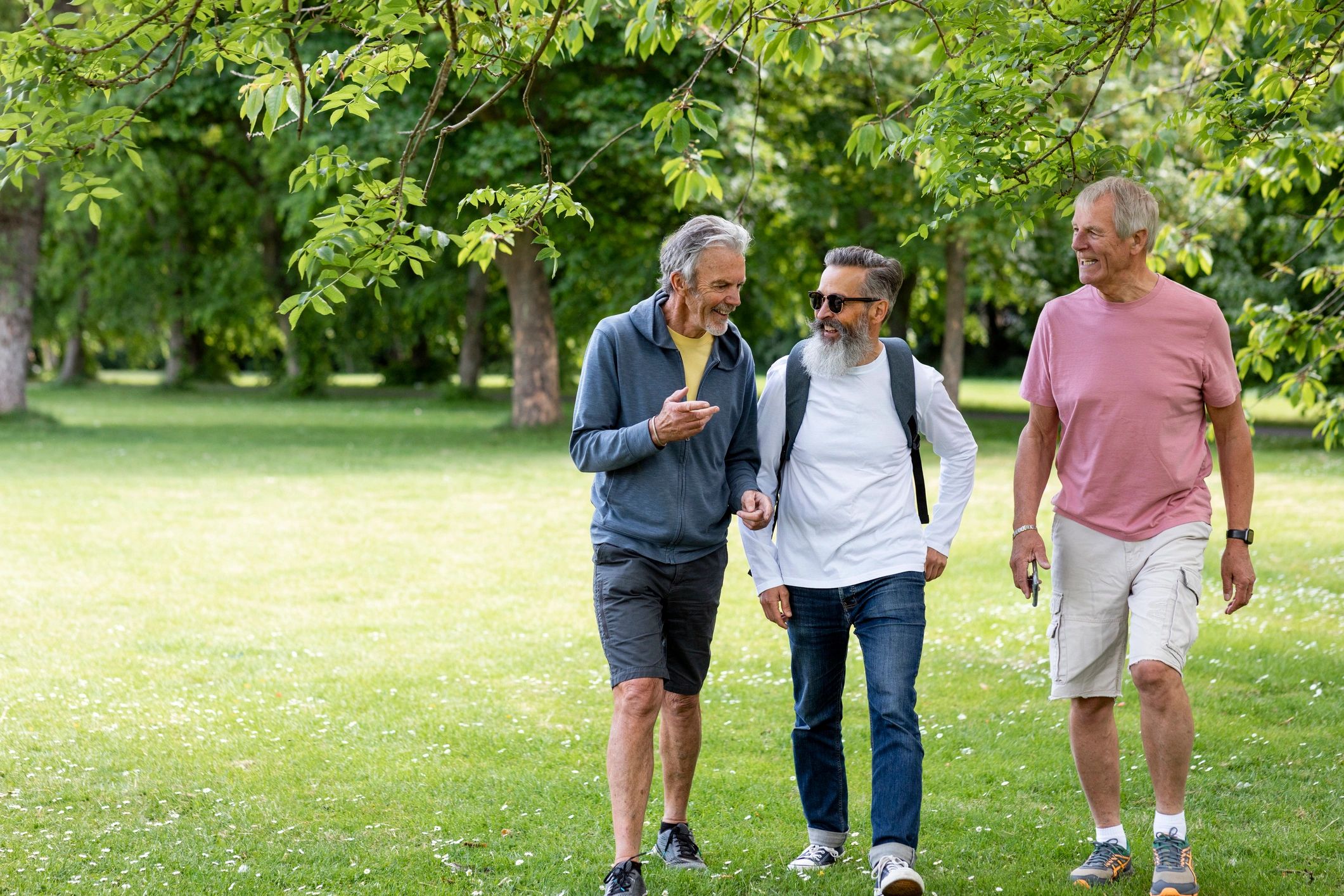 Group of older bald men walking together outdoors