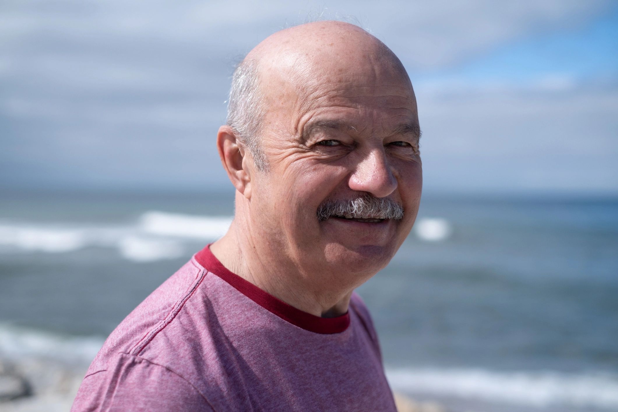 Portrait of an elderly bald man with a mustache
